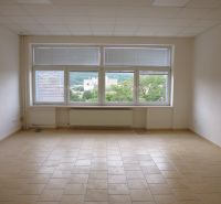 Spacious offices with tiled floors and large windows with a view.
