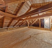 Attic in a family house with a wooden structure and a floor made of OSB boards.