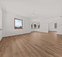 Interior of a family house with white walls and a wooden decor floor.