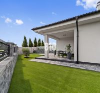A grassy yard and terrace of a family house in Nitra with garden furniture.