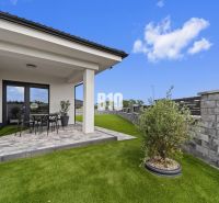 A family house in Nitra with a terrace, garden, and modern fencing.