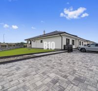 A family house in Nitra with a paved courtyard and a landscaped lawn.