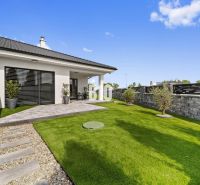 A family house in Nitra with a garden, lawn, and terrace surrounded by a wall.