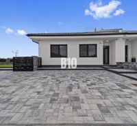 A family house in Nitra with stone paving and a simple exterior design.