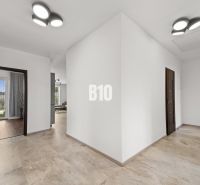 The interior of a family house with white walls and tiles in a neutral shade.