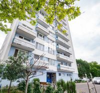 Apartment building in Nitra with trees and parking in front of a 3-room apartment.