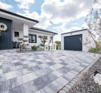 A family house in Nitra with paving, a garage, and a decorative entrance.