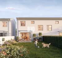 A family house in Nitra with a garden, a playing child, and a dog.
