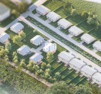 Aerial view of family houses in a residential area in Nitra surrounded by greenery.