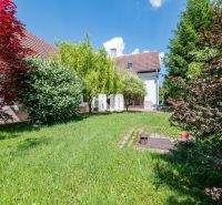 A well-maintained garden of a family house in Nitra, surrounded by greenery and flowers.