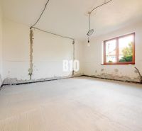 Room for renovation with a window and lighting in a family house.
