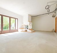A family house with large windows and a fireplace, waiting for the interior to be completed.