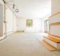 A spacious living room in a family house prepared for renovation.