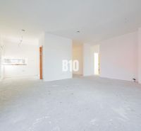 A spacious interior with white walls and a concrete floor in a family house.