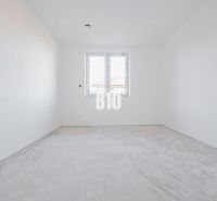 Empty room in a family house with a concrete floor and a plastic window.