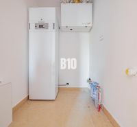 A utility room with equipment in a family house, containing modern technologies for efficient heating.