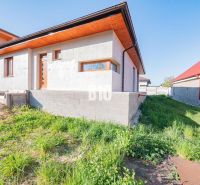 A family house in Nitra with an unpainted facade and a grassy plot.