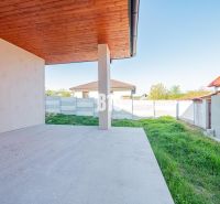 A family house in Nitra with a terrace and a view of the garden with a grassed area.
