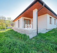 A family house in Nitra with a concrete terrace and a green lawn in the garden.