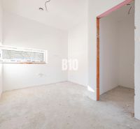 Empty room with a skylight and an open passage in a family house.