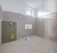 An unfinished room with a window and preparation for installation in a family house.