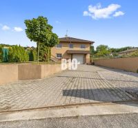 A family house in Nitra with a paved driveway and a landscaped garden.