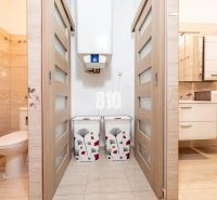 Bathroom and toilet in a family house with tiles and sliding doors.