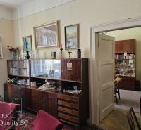 Living room in retro style in a 2-room apartment with a wooden decor floor.