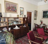 Living room in a two-room apartment, with wooden decorations and red furniture.