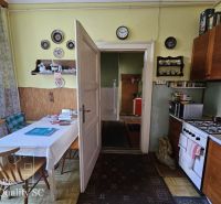 A kitchen in a 2-room apartment with retro decor and a dining table.