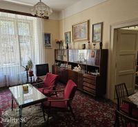 Living room in a two-room apartment with retro furniture and red armchairs.