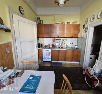 A kitchen unit with a wooden decor in a 2-room apartment with traditional decorations.