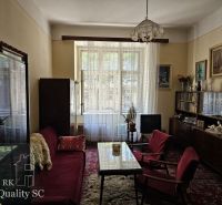 Living room in a 3-room apartment with retro-style furniture and a carpet.