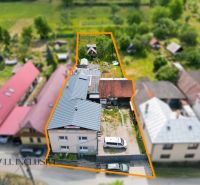 A family house in Dúbravica with a courtyard and garden, surrounded by neighboring houses.