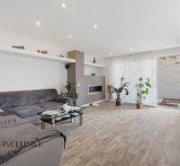 Living room in a family house with comfortable seating and a wooden decor floor.