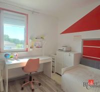 Children's room with a table, chair, bed, and floor with wooden decor in a 4-room apartment.