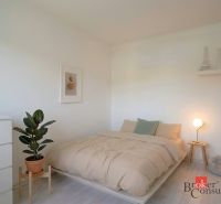 Bedroom in a 4-room apartment with floor decor and a houseplant.
