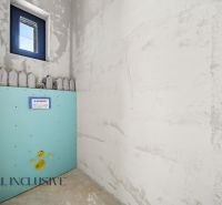 Unplastered bathroom with preparation for toilet installation in a family house.