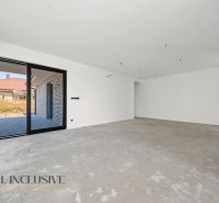 A spacious room in a family house with a concrete floor, view of the terrace.