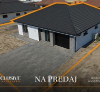 A family house in Hviezdoslavov with a dark roof and a paved courtyard, for sale.