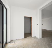 Interior of a family house with white walls and undecorated floor.