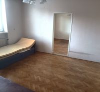Interior of a family house with a bed and a wooden decor floor.