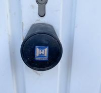 Lock and handle on white doors in garages on Belanska Street in Košice.