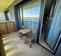 A balcony with wooden seating in a 1-room apartment on Gen. Goliána Street in Trnava.