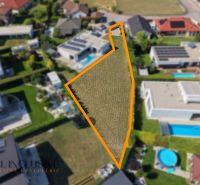A residential plot on Mlynský Klin in Senec, surrounded by family houses.