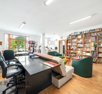 A work office with a library and a wooden decor floor in a 3-room apartment.