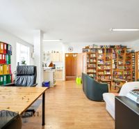 A spacious living room with a library and wood-patterned flooring in a 3-room apartment.