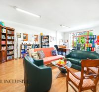 Comfortable seating and bookshelves in a 3-room apartment with a wooden decor floor.