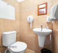 Bathroom with a toilet in a 3-room apartment, tiled with light tiles.