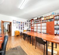 Office space with archive, wooden decor flooring, large table, chairs.
